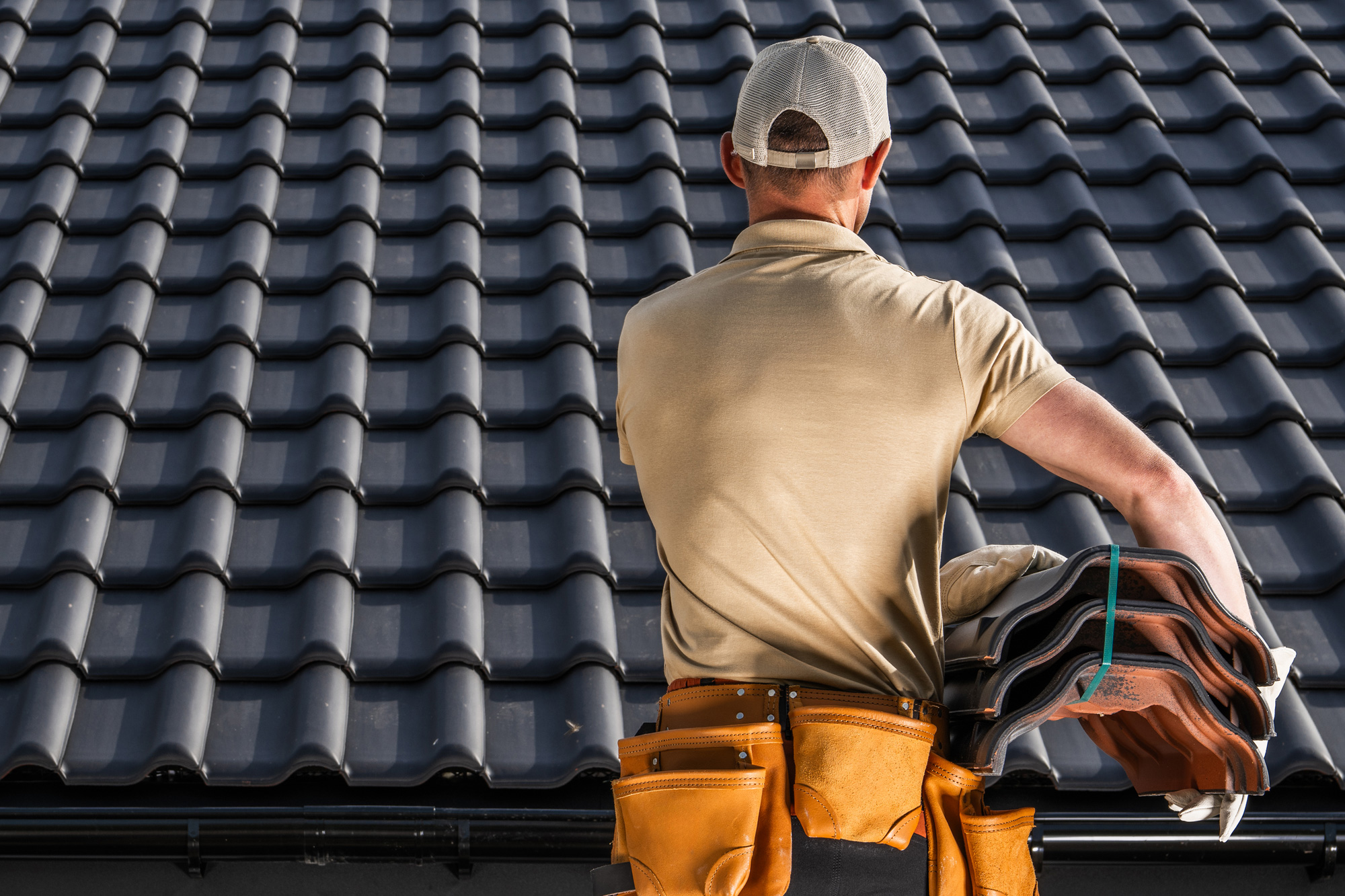 Roofer standing in front of completed roof in Weston-super-Mare Roofer standing in front of completed roof in Weston-super-Mare