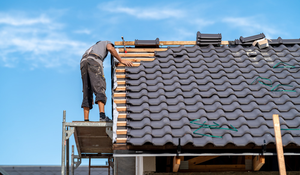 Roofer installing new roof Roofer installing new roof